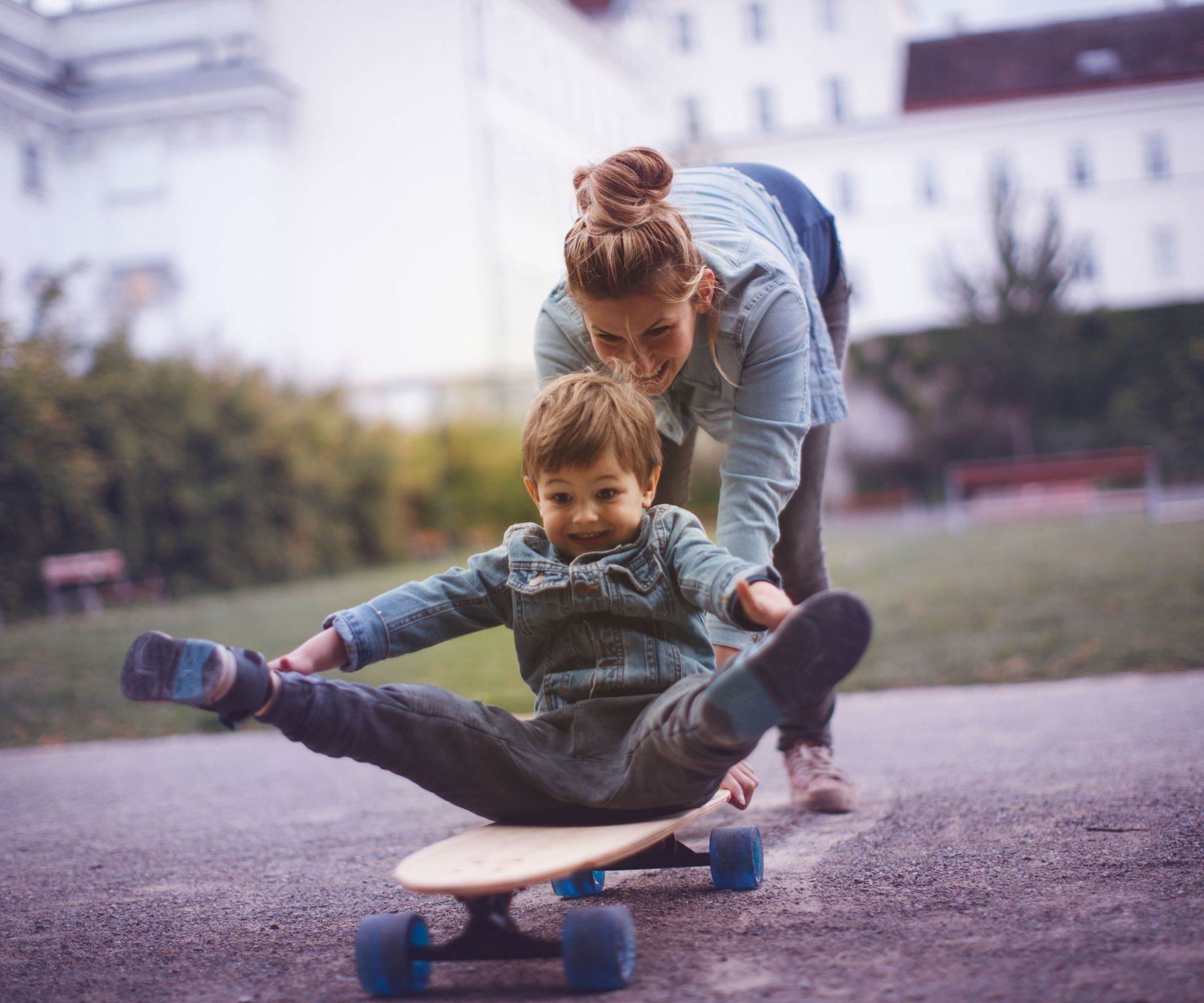 Sohn und Mutter spielen mit Skateboard